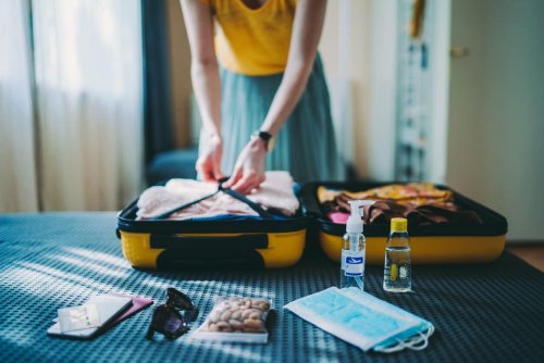Woman packing suitcase, preparing for vacation