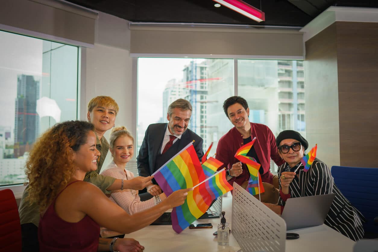Diverse group of Business people celebrate with rainbow flags
